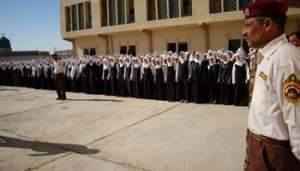 About 300 girls stand in formation in the courtyard of the Huda Girls School in Tarmiyah, northwest of Baghdad, during the official reopening Jan. 5. The school was under renovation since 2006. A foiled terror plot set back the opening by almost a year.